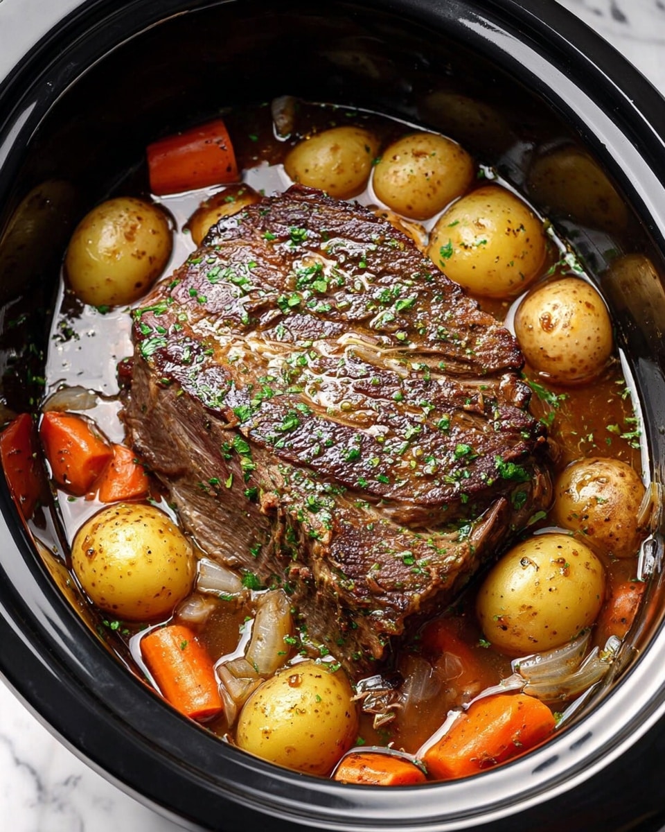 The image shows a large piece of cooked beef pot roast sitting in the center of a black slow cooker. Surrounding the beef are whole small yellow potatoes and large chunks of orange carrots, along with bits of cooked onion, all submerged in a rich brown broth. The surface of the meat is glossy and seasoned with visible herbs, mainly green parsley sprinkled over the top. The slow cooker sits on a white marbled surface. Photo taken with an iphone --ar 4:5 --v 7
