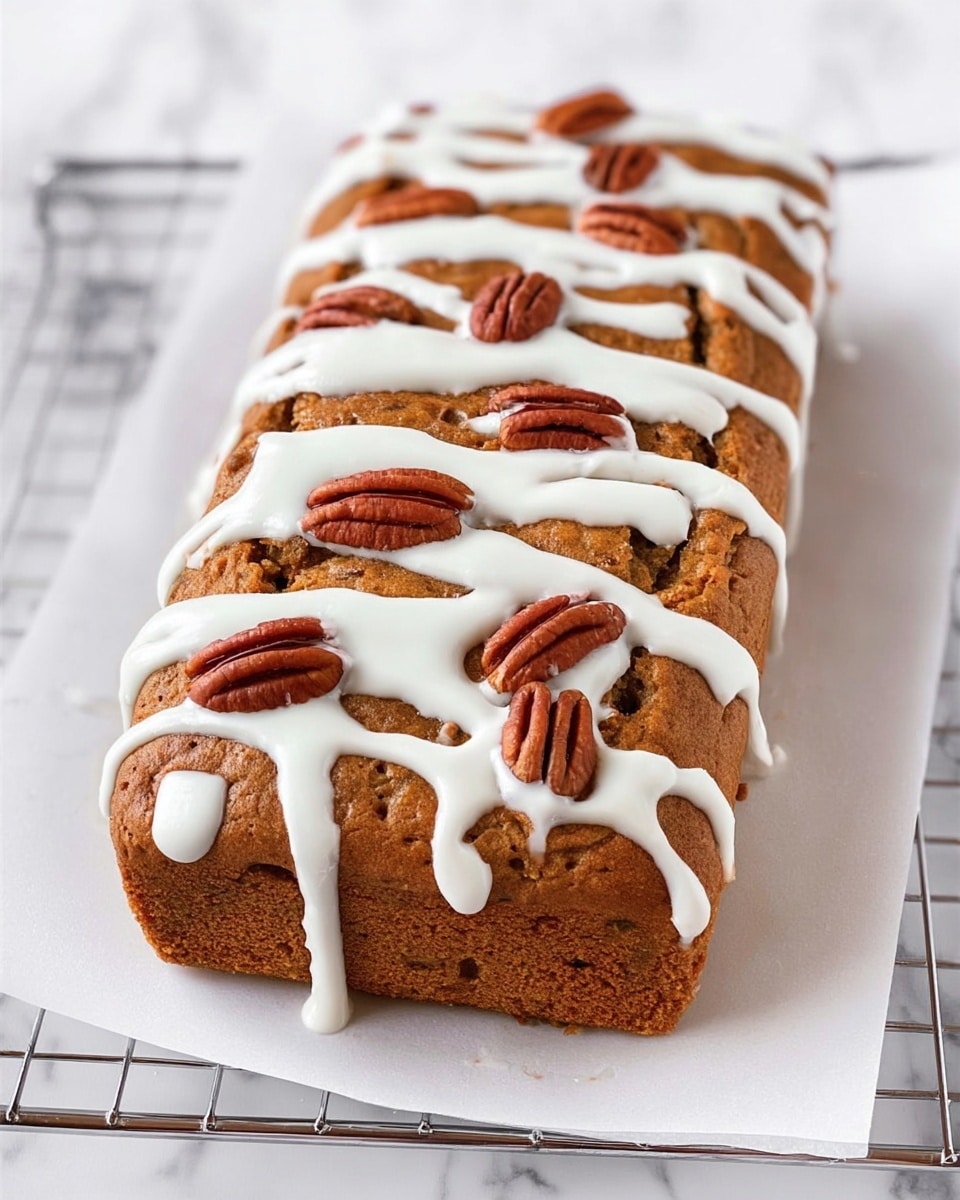 A rectangular brown cake with a slightly rough texture sits on a white piece of paper over a wire rack, all placed on a white marbled surface. The cake is decorated with uneven, thick white icing stripes that run horizontally across the top, with some icing dripping off the edges. Scattered across the cake’s top are several whole pecan nuts that add a dark brown, glossy contrast to the soft brown cake and white icing. Photo taken with an iphone --ar 4:5 --v 7