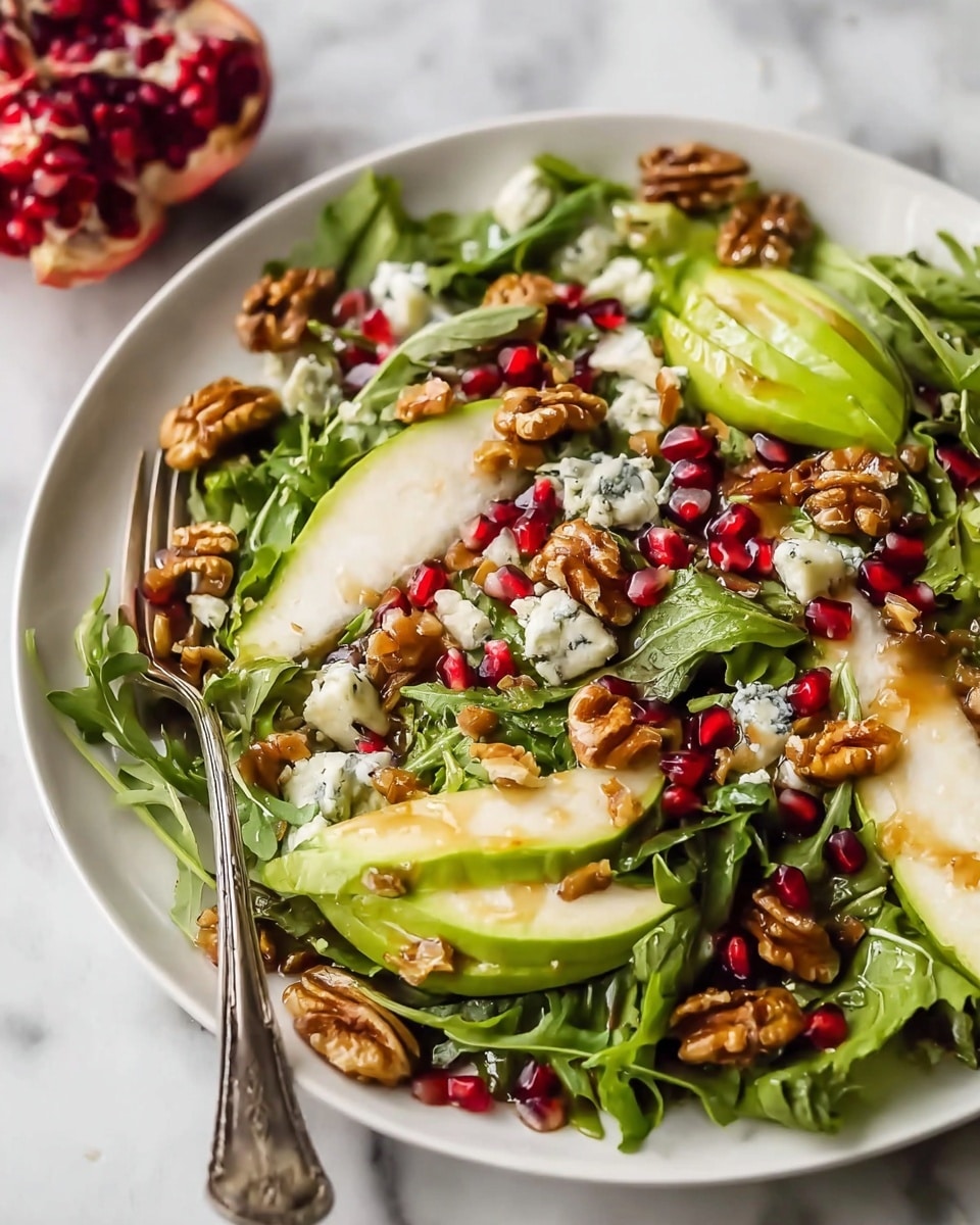 A white bowl filled with a fresh salad showing about four layers of ingredients starting with green leafy spinach as the base. On top, there are bright yellow peach slices scattered evenly. Next, small red pomegranate seeds sprinkled all over add color and texture. Topping the salad are a few pecan halves spread around, and thin green herb sprigs are placed for garnish. The bowl sits on a white marbled surface with a beige cloth beside it and a small white bowl containing a light beige dressing in the background. photo taken with an iphone --ar 4:5 --v 7