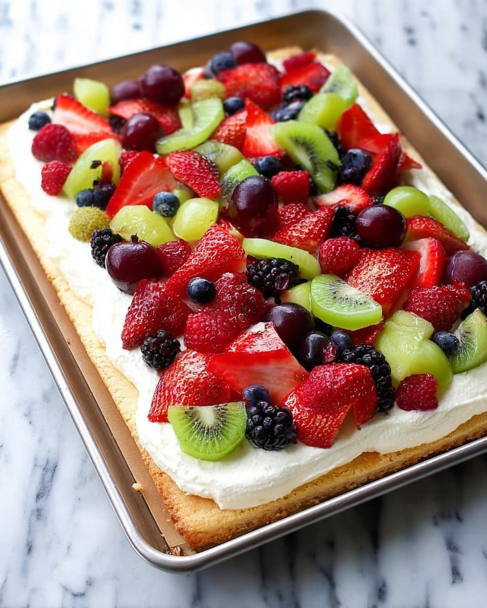 A rectangular dessert on a metal tray shows three main layers: the base is a light golden-brown crust with a slightly raised edge; on top of this is a thick layer of smooth, white creamy spread; scattered over the cream are various fresh fruits, including bright red sliced strawberries with white interiors and tiny seeds, small green kiwi pieces with black seeds, round red grape halves with juicy interiors, dark purple-black blackberries, red raspberries, and small round dark blue blueberries, all giving a colorful and lively look. The tray sits on a white marbled surface. photo taken with an iphone --ar 4:5 --v 7